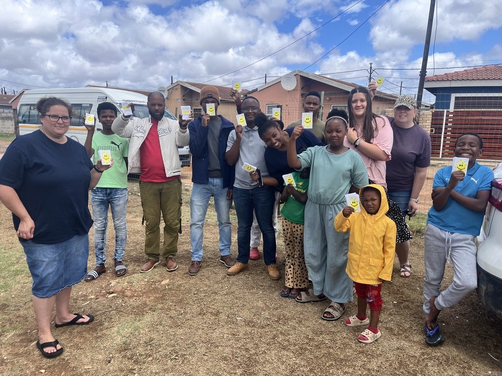 A group sharing Gospel tracts during outreach in South Africa